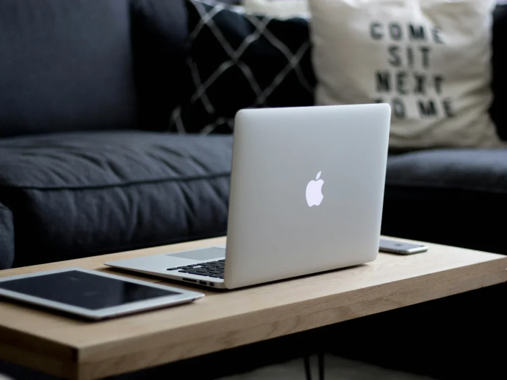 Laptop and iPad on the table next to the sofa