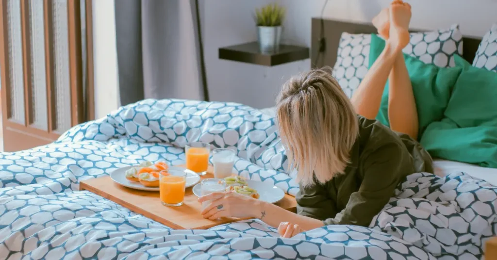 Use a tray table to load food and put it on the bed to eat