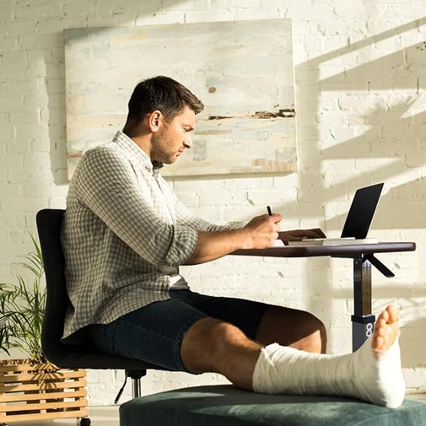 a men working on the Adjustable Overbed Bedside Table With Wheels