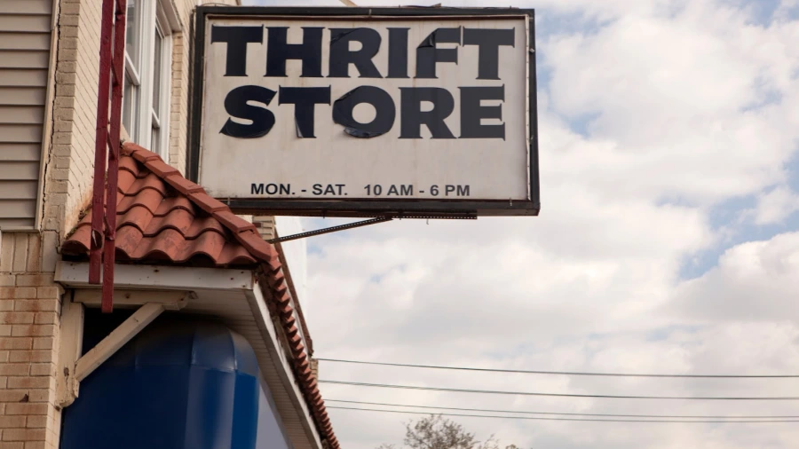 an old and tattered thrift store sign that sells cheap furniture